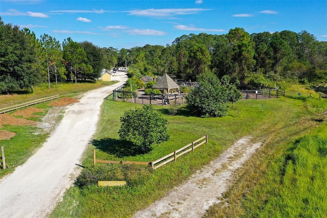 view of home's community with a rural view and a lawn