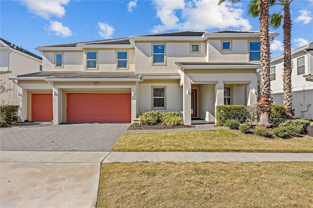 view of front of property featuring a garage and a front lawn