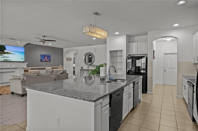 kitchen with sink, a kitchen island with sink, white cabinetry, black appliances, and a textured ceiling