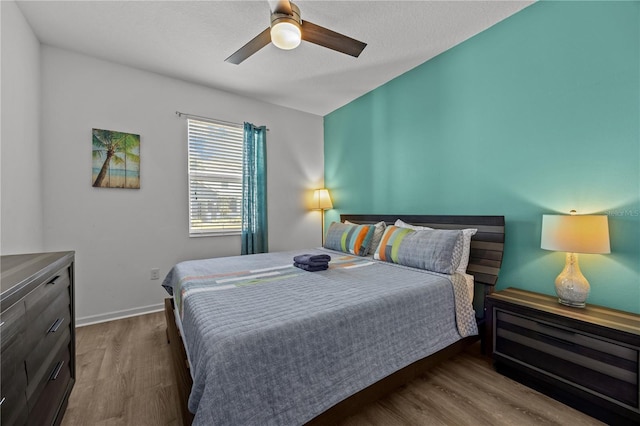 bedroom with hardwood / wood-style flooring and ceiling fan