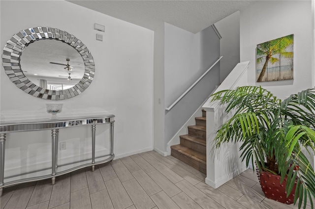 foyer entrance featuring a textured ceiling