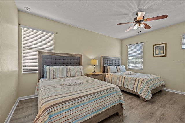 bedroom with ceiling fan and light wood-type flooring