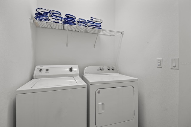 clothes washing area featuring washer and clothes dryer