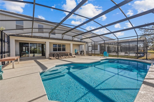 view of pool featuring a patio and glass enclosure