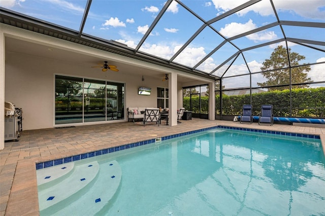 view of pool with ceiling fan, a patio, and a lanai