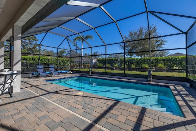 view of pool with a patio and a lanai