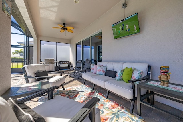 sunroom / solarium featuring ceiling fan