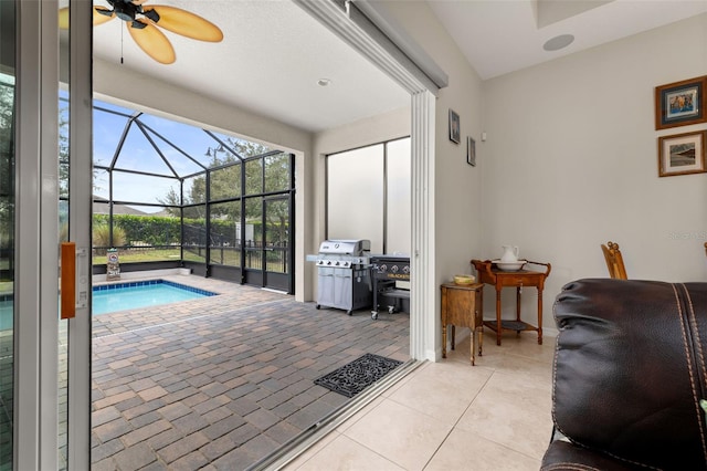 view of pool featuring ceiling fan and a grill