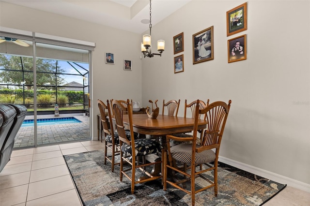 tiled dining area featuring a chandelier