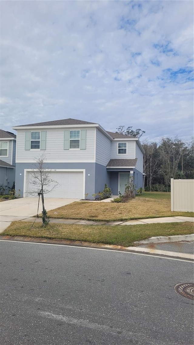 view of front of property featuring a front lawn and a garage