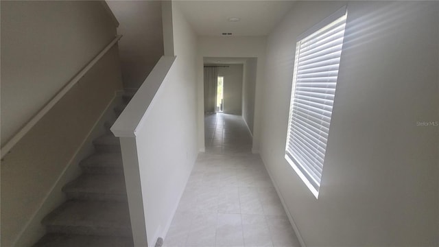 hallway featuring light tile patterned floors