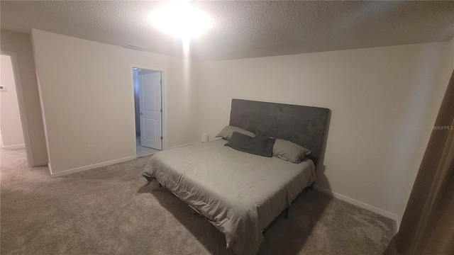 bedroom with carpet floors and a textured ceiling