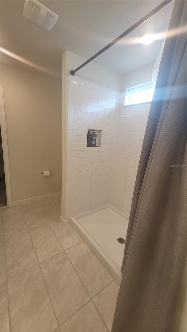 bathroom featuring tile patterned floors and a shower with shower curtain