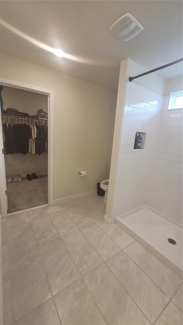 bathroom featuring walk in shower and tile patterned flooring