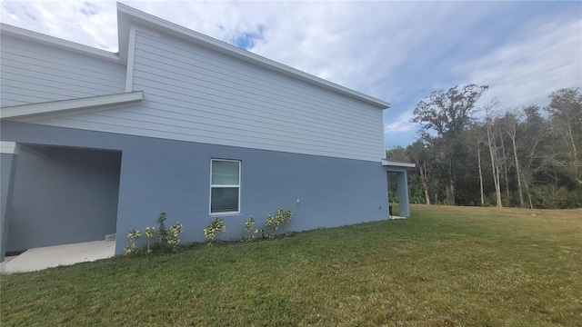 view of property exterior with a yard