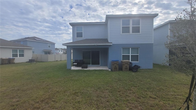 rear view of house with a patio area and a lawn