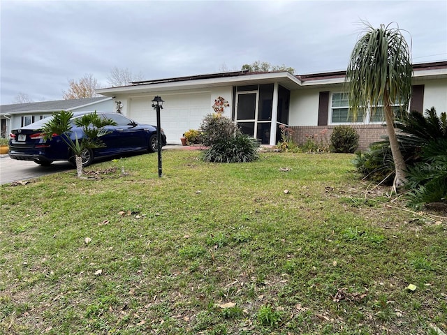 ranch-style home with a garage and a front yard