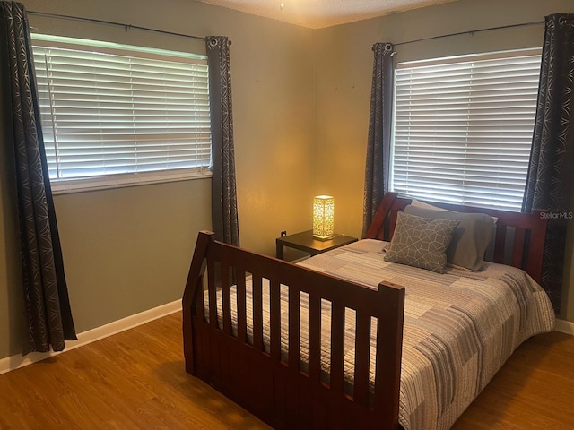 bedroom with hardwood / wood-style floors