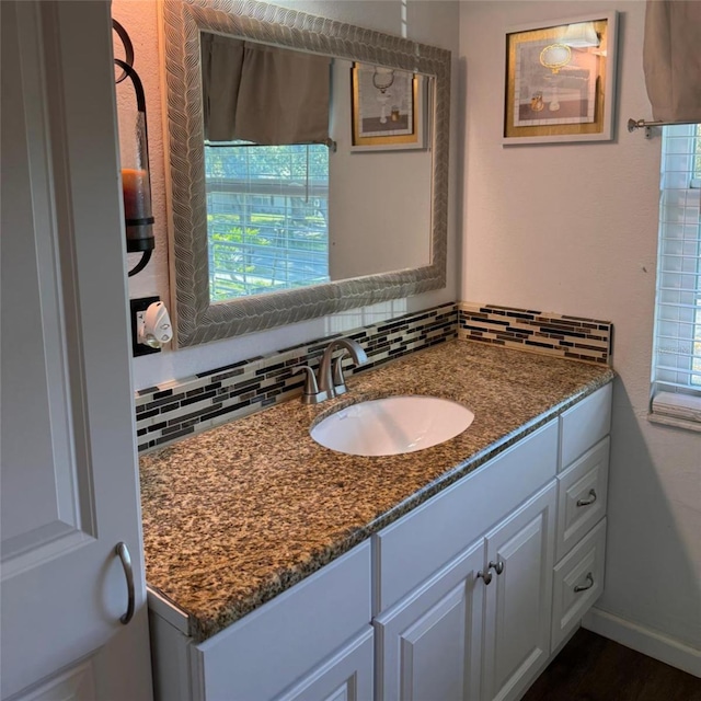 bathroom with vanity and decorative backsplash