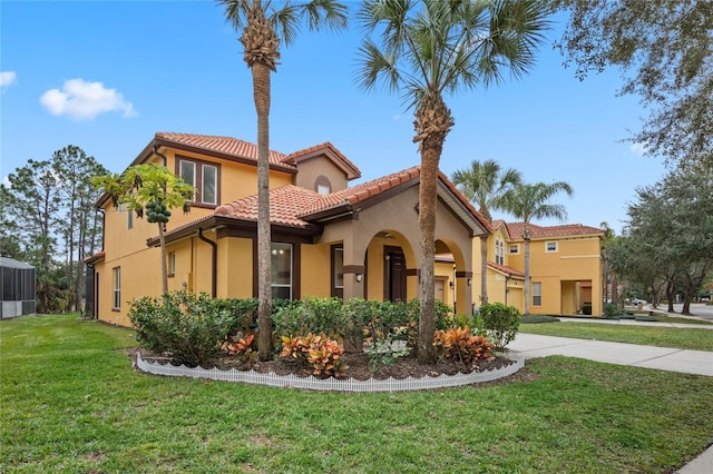 mediterranean / spanish-style home featuring a front yard