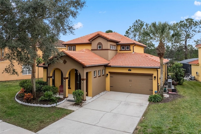 mediterranean / spanish-style home with a front yard and a garage