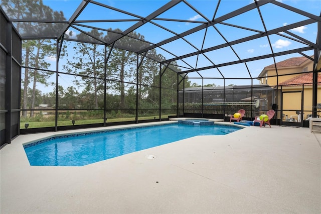 view of pool featuring an in ground hot tub, glass enclosure, and a patio