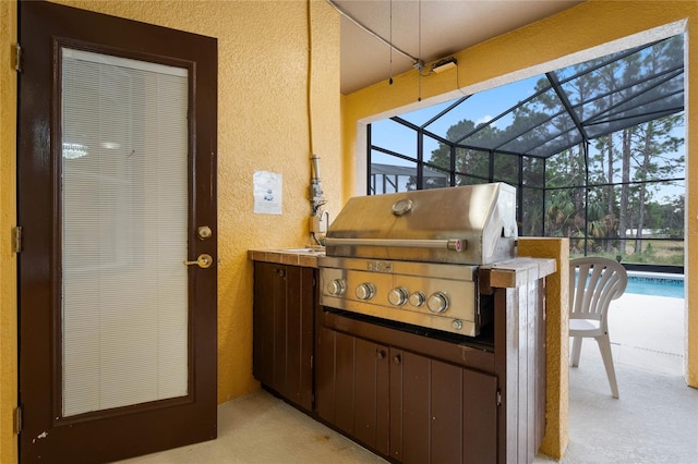 view of patio / terrace featuring glass enclosure, area for grilling, and grilling area