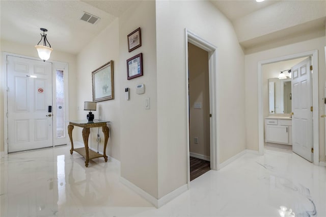 foyer entrance featuring a textured ceiling