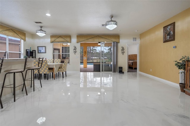 dining space featuring a wealth of natural light and a notable chandelier