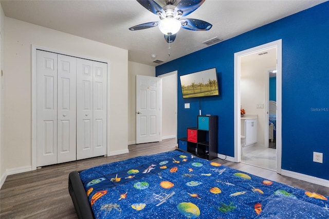 bedroom featuring ceiling fan, ensuite bathroom, a textured ceiling, and wood-type flooring