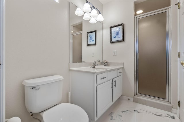 bathroom featuring toilet, vanity, and a shower with shower door