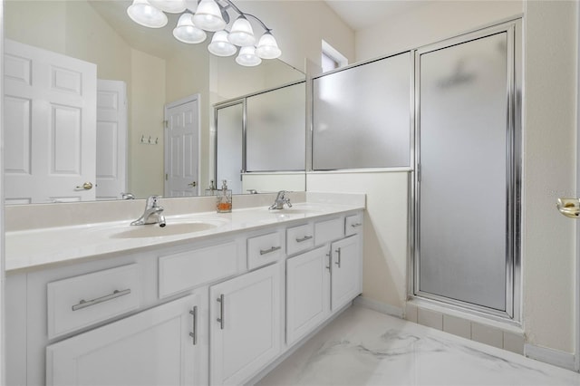 bathroom featuring a shower with door and vanity