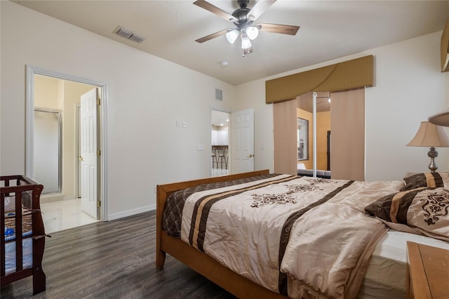 bedroom featuring ensuite bath, ceiling fan, and dark hardwood / wood-style flooring