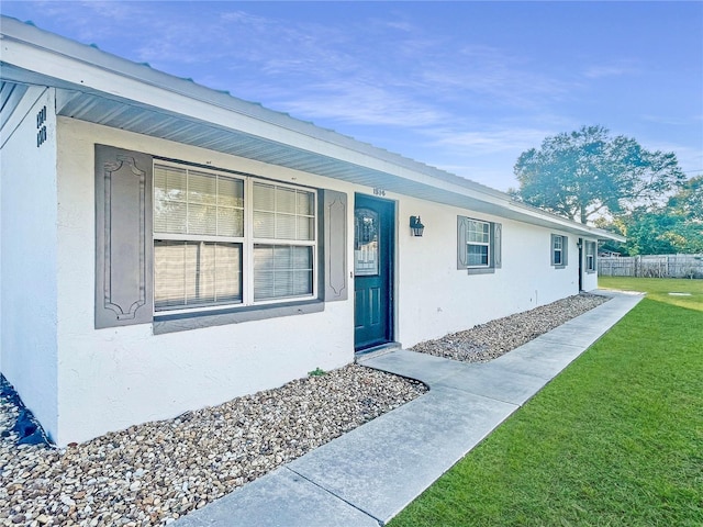 entrance to property with a yard