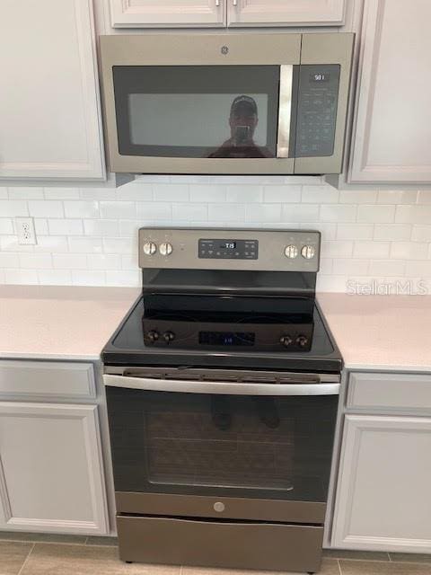 kitchen featuring white cabinets and appliances with stainless steel finishes