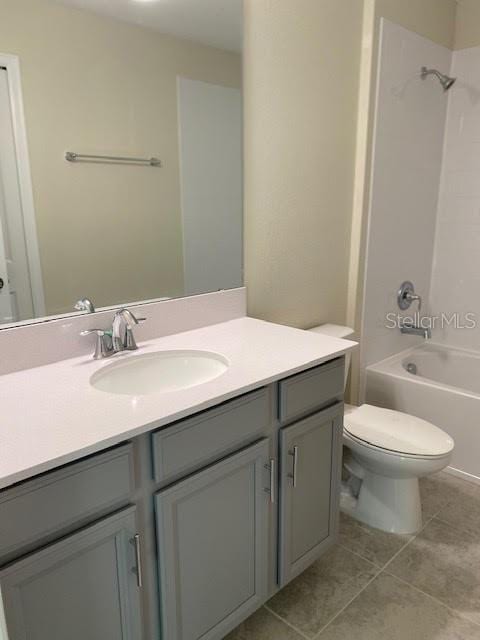 full bathroom with toilet, tile patterned flooring, tub / shower combination, and vanity