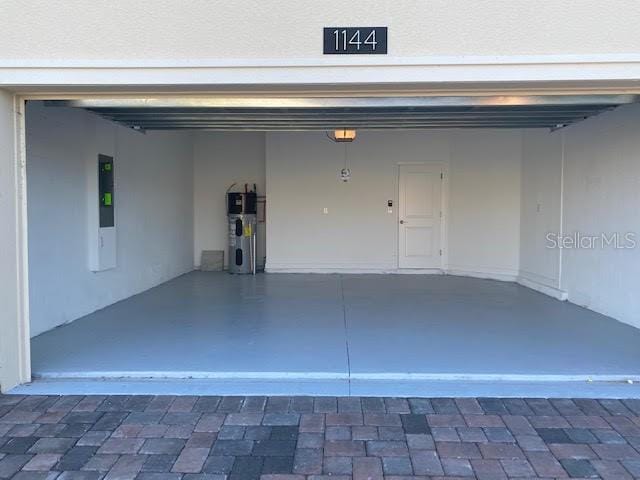 garage featuring water heater and a garage door opener