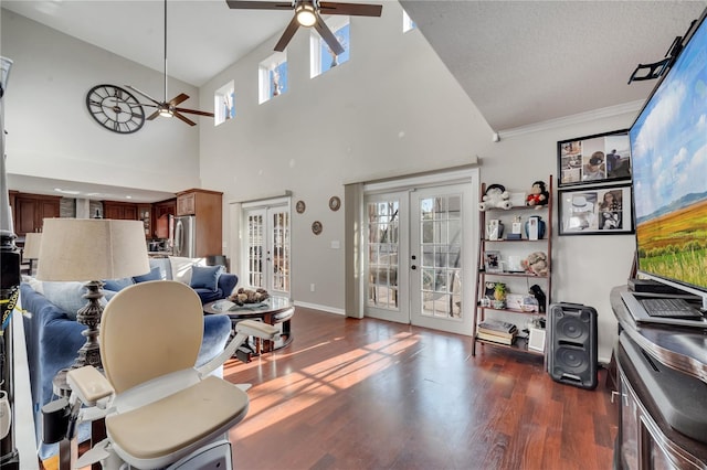 living room featuring a high ceiling, ceiling fan, dark wood-type flooring, french doors, and a textured ceiling