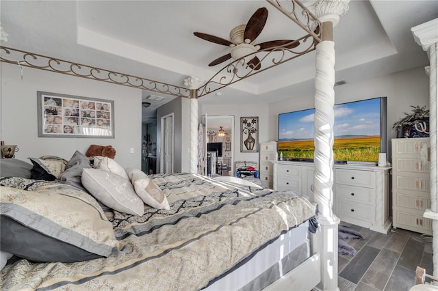 bedroom with a raised ceiling and ceiling fan