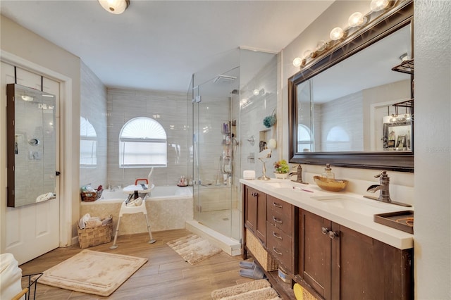 bathroom featuring shower with separate bathtub, vanity, and hardwood / wood-style flooring