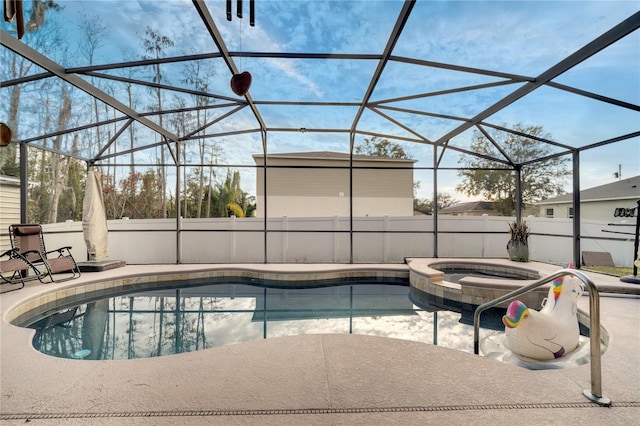 view of pool with a lanai, an in ground hot tub, and a patio area