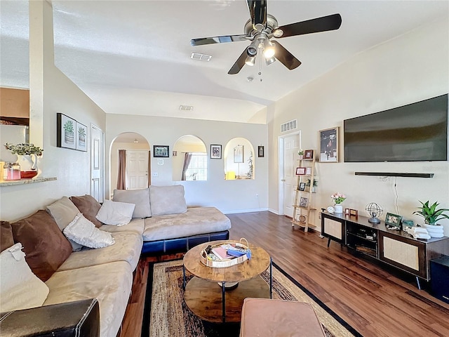 living room with lofted ceiling, dark hardwood / wood-style flooring, and ceiling fan