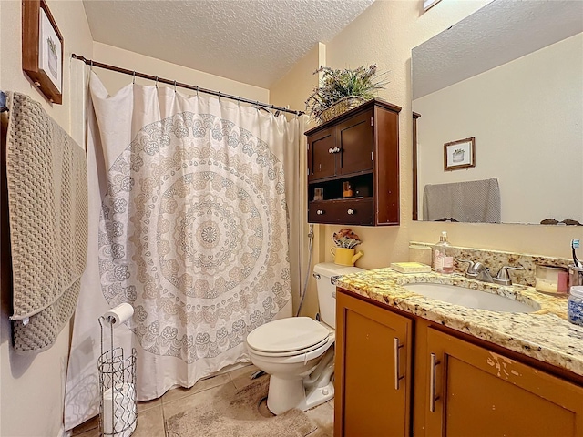 bathroom featuring tile patterned floors, vanity, toilet, and a textured ceiling