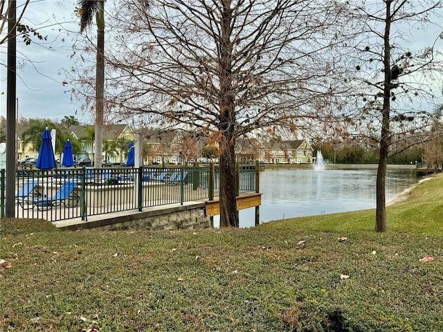 exterior space featuring a lawn and a water view