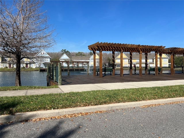 view of property's community featuring a pergola and a water view