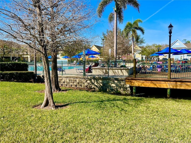 view of yard with a swimming pool side deck