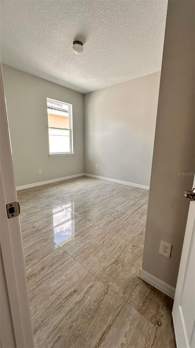 empty room featuring a textured ceiling