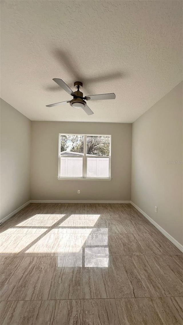 unfurnished room featuring a textured ceiling and ceiling fan