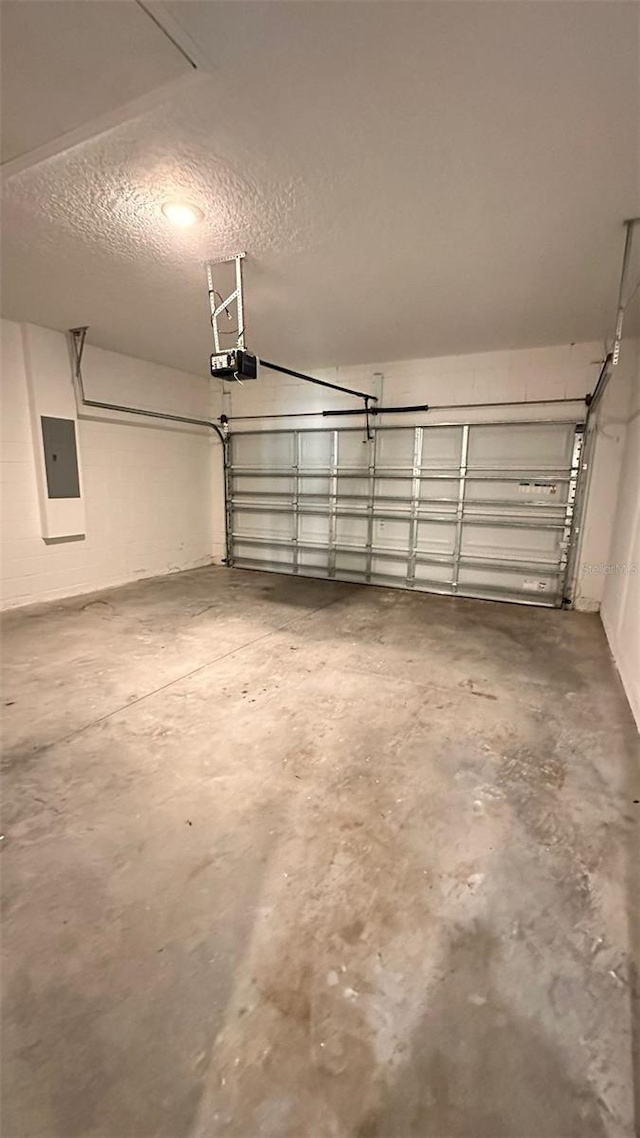 garage with electric panel and a garage door opener