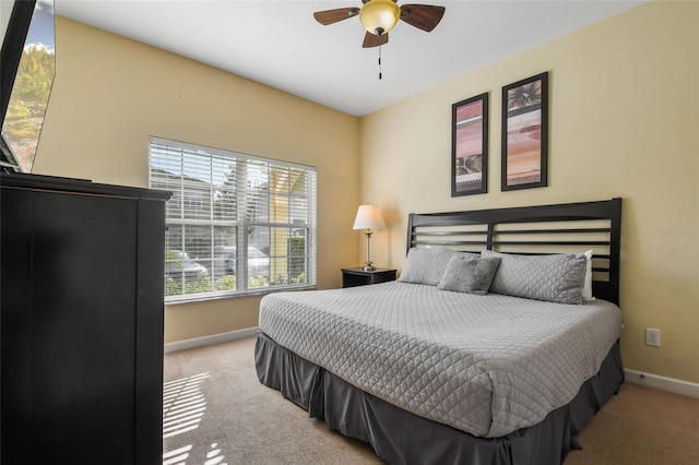 bedroom featuring ceiling fan and light colored carpet